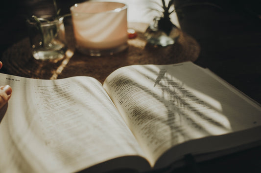 a person is reading a book on a table
