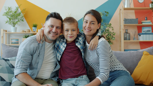 A happy family of three posing for a photo.